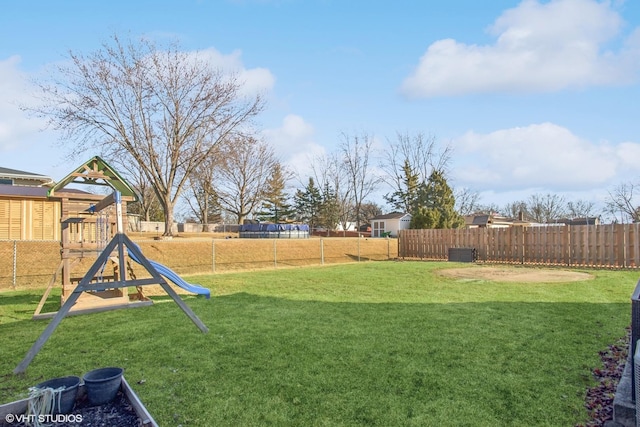 view of yard with a fenced backyard and a playground