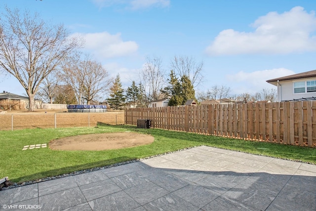 view of yard with fence and a patio