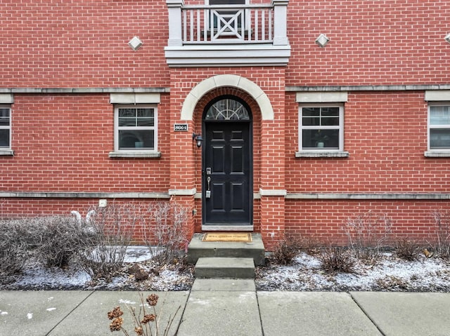 view of snow covered property entrance