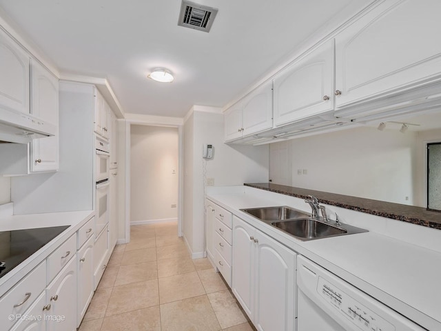 kitchen featuring sink, white appliances, white cabinets, and light tile patterned flooring