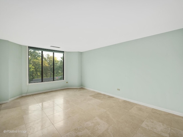 spare room featuring light tile patterned floors