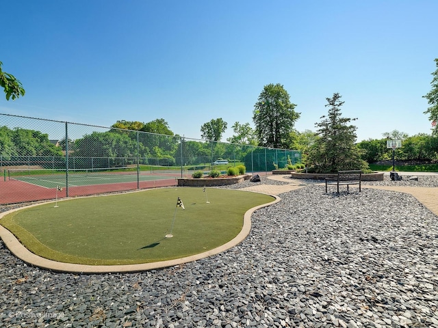 view of home's community with tennis court