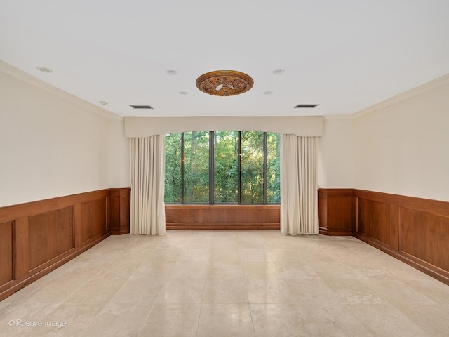 spare room featuring ornamental molding