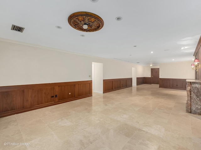 empty room featuring ornamental molding