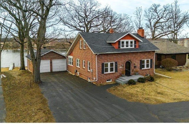 view of front of home featuring a garage and an outdoor structure