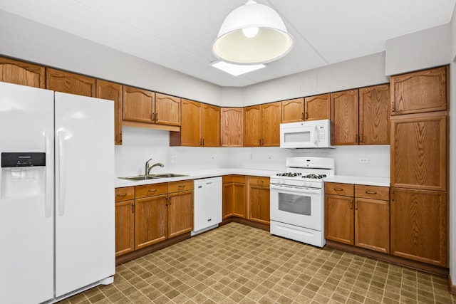 kitchen featuring white appliances and sink