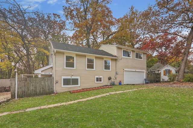 view of front of property featuring a garage and a front lawn