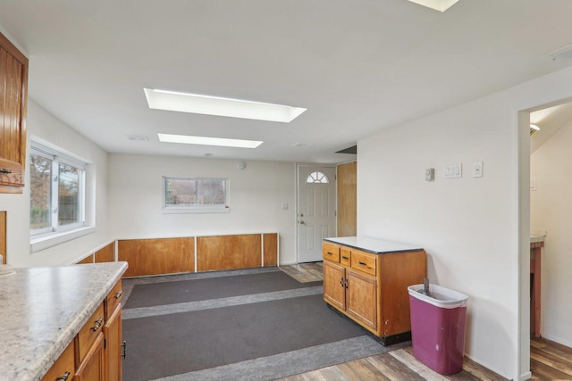 kitchen with dark hardwood / wood-style floors and a skylight