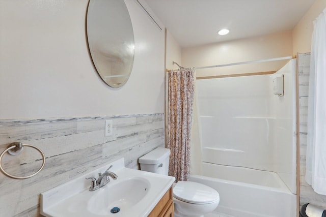 full bathroom featuring shower / bathtub combination with curtain, vanity, and toilet