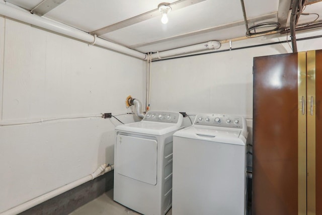 clothes washing area with washer and clothes dryer