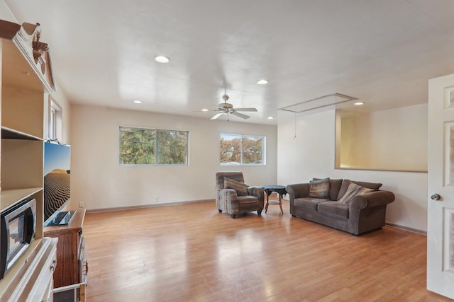 living room featuring ceiling fan and light hardwood / wood-style floors