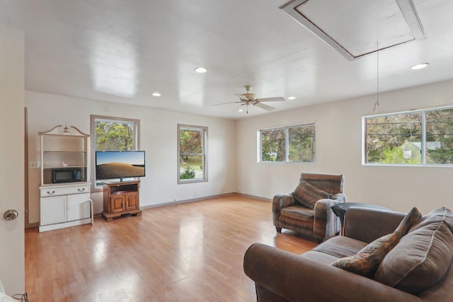 living room with plenty of natural light and light hardwood / wood-style floors