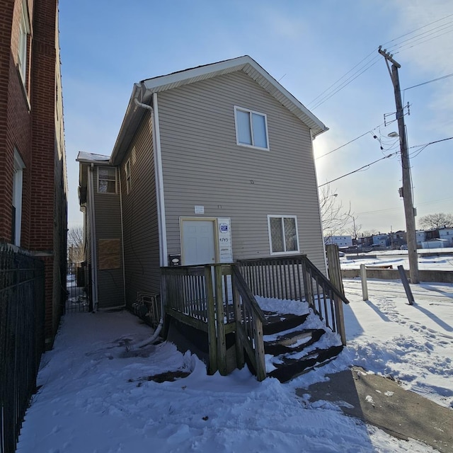 view of snow covered rear of property