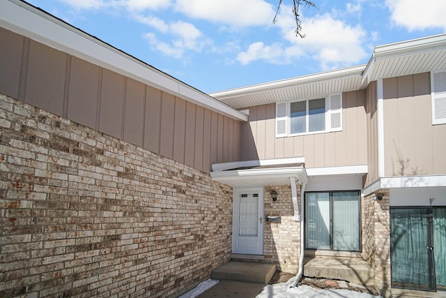 property entrance with brick siding