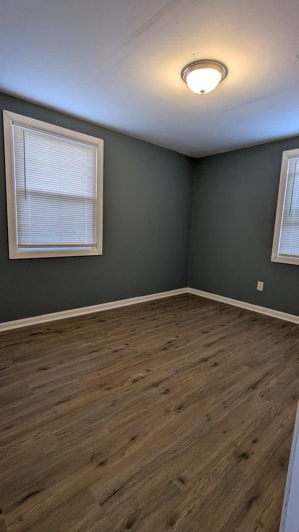 spare room with dark hardwood / wood-style flooring