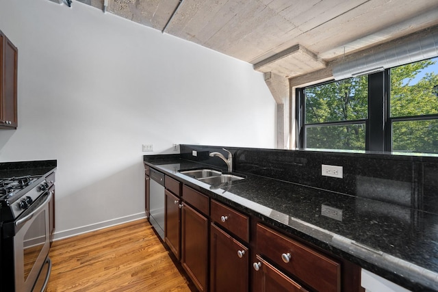 1150 W 15th St Unit 232, Chicago, IL 60608 - kitchen with appliances with stainless steel finishes, sink, dark stone countertops, dark brown cabinets, and light wood-type flooring