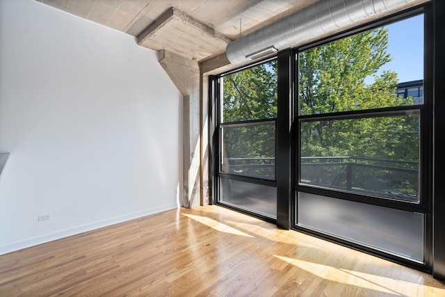 1150 W 15th St Unit 232, Chicago, IL 60608 - spare room featuring a wealth of natural light and light wood-type flooring