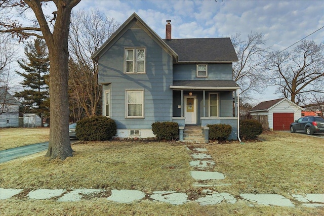 victorian-style house featuring a porch, an outbuilding, a chimney, and a front lawn