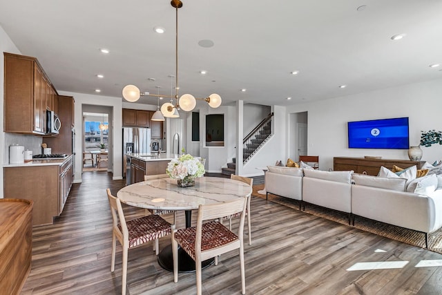 dining space with sink and dark hardwood / wood-style flooring