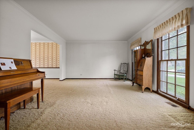 sitting room featuring crown molding, light colored carpet, and baseboards