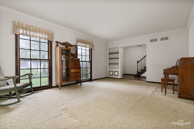 unfurnished room featuring crown molding, carpet floors, stairs, and baseboards