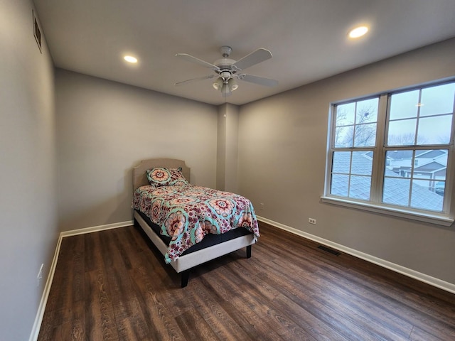 bedroom featuring wood finished floors, visible vents, and baseboards