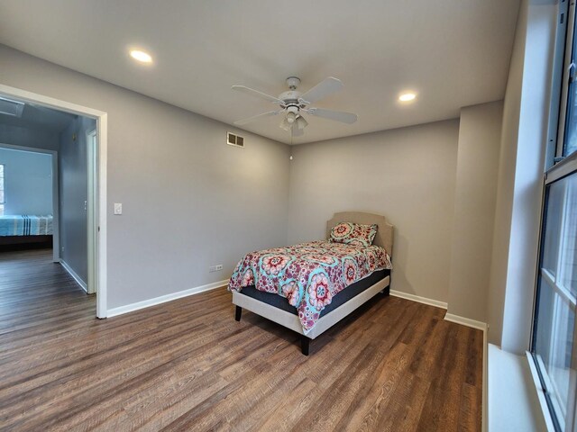 bedroom with recessed lighting, wood finished floors, visible vents, and baseboards