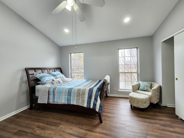 bedroom with lofted ceiling, multiple windows, wood finished floors, and baseboards