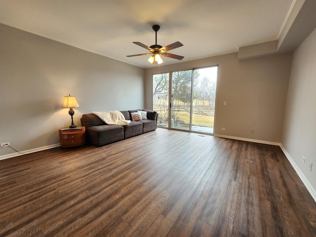 unfurnished living room with ceiling fan, dark wood-type flooring, crown molding, and baseboards