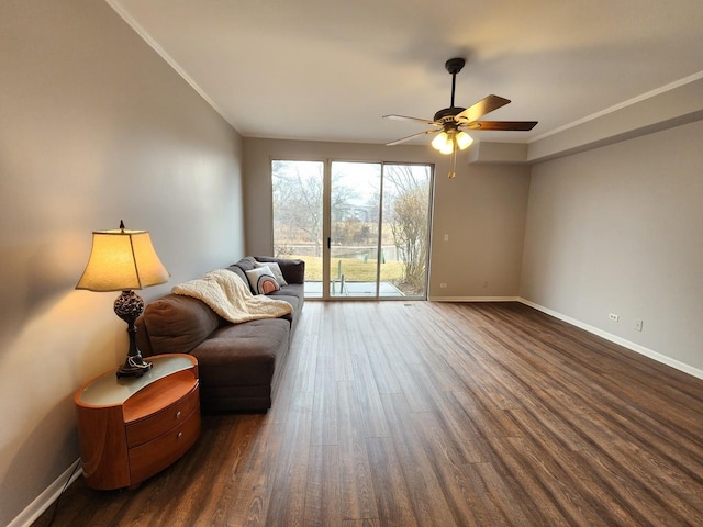 living area with dark wood-style flooring, crown molding, baseboards, and ceiling fan