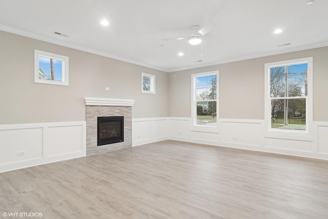 unfurnished living room with crown molding, ceiling fan, and light wood-type flooring