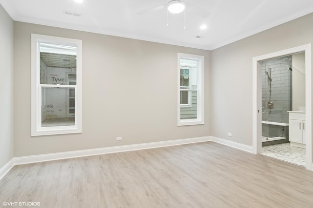 spare room featuring ceiling fan, ornamental molding, and light hardwood / wood-style floors