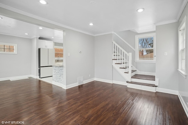 unfurnished living room featuring hardwood / wood-style flooring and ornamental molding