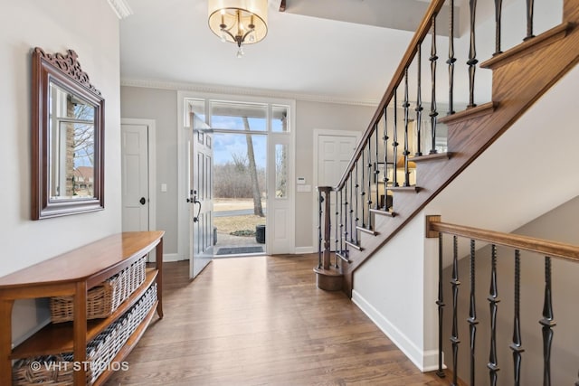 foyer with crown molding and hardwood / wood-style flooring