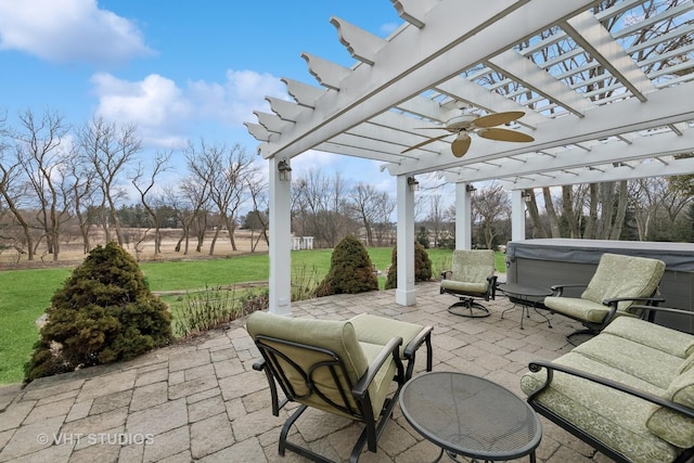 view of patio / terrace with a hot tub, ceiling fan, and a pergola