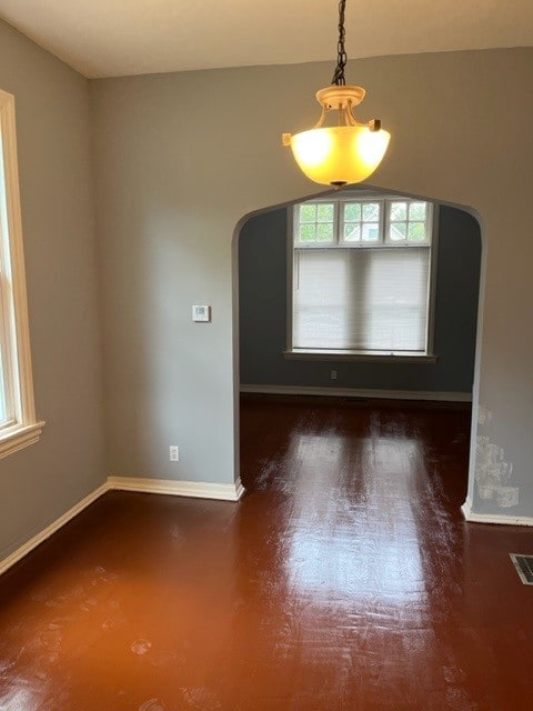 spare room with dark hardwood / wood-style flooring and vaulted ceiling