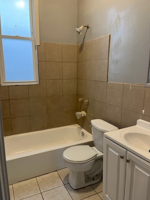 bathroom with toilet, tile walls, shower / bathtub combination, and tile patterned flooring