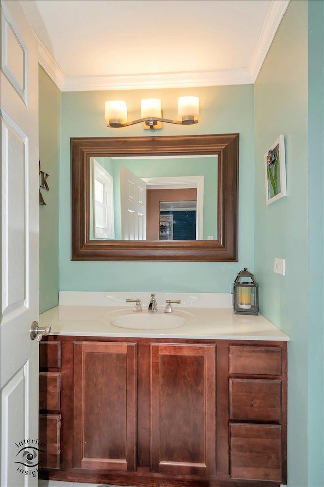 bathroom with ornamental molding and vanity