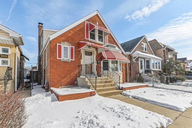 view of front of home featuring fence, brick siding, a residential view, and a chimney