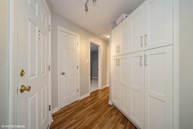 hall with hardwood / wood-style flooring