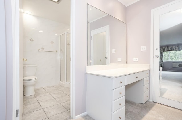 bathroom with walk in shower, vanity, toilet, and tile patterned flooring