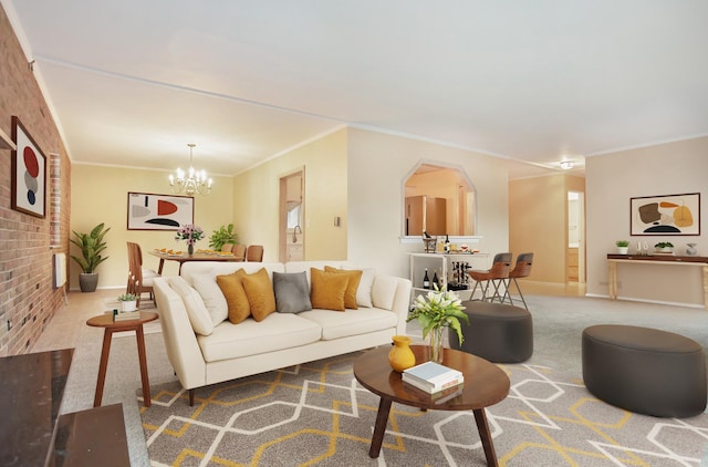 living room with brick wall, ornamental molding, carpet, and an inviting chandelier