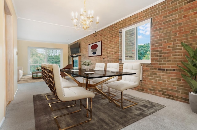 dining space featuring a notable chandelier, carpet floors, ornamental molding, and brick wall