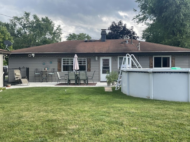 rear view of house with a yard and a patio area