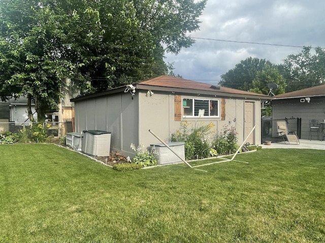 view of outbuilding featuring central AC and a yard