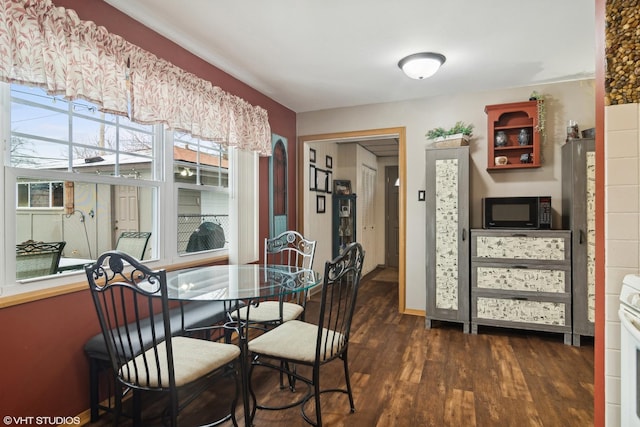 dining area featuring dark wood-type flooring