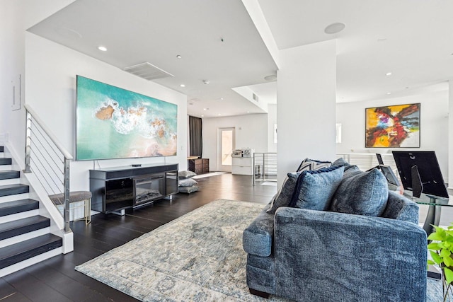 living area featuring visible vents, stairway, recessed lighting, a fireplace, and wood finished floors