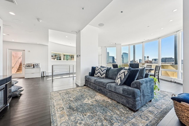 living room featuring visible vents, a view of city, wood finished floors, recessed lighting, and stairway