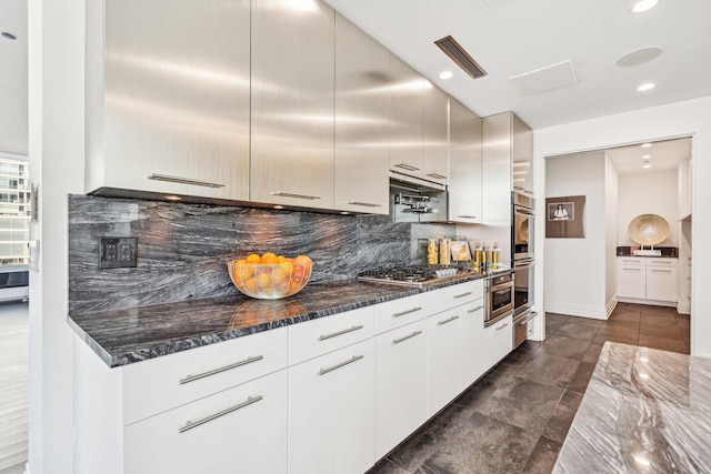 kitchen with visible vents, decorative backsplash, dark stone countertops, recessed lighting, and stainless steel appliances