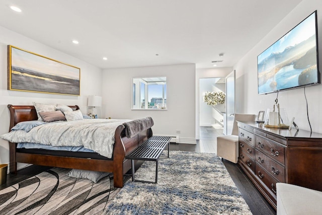 bedroom featuring dark wood finished floors, recessed lighting, and baseboards